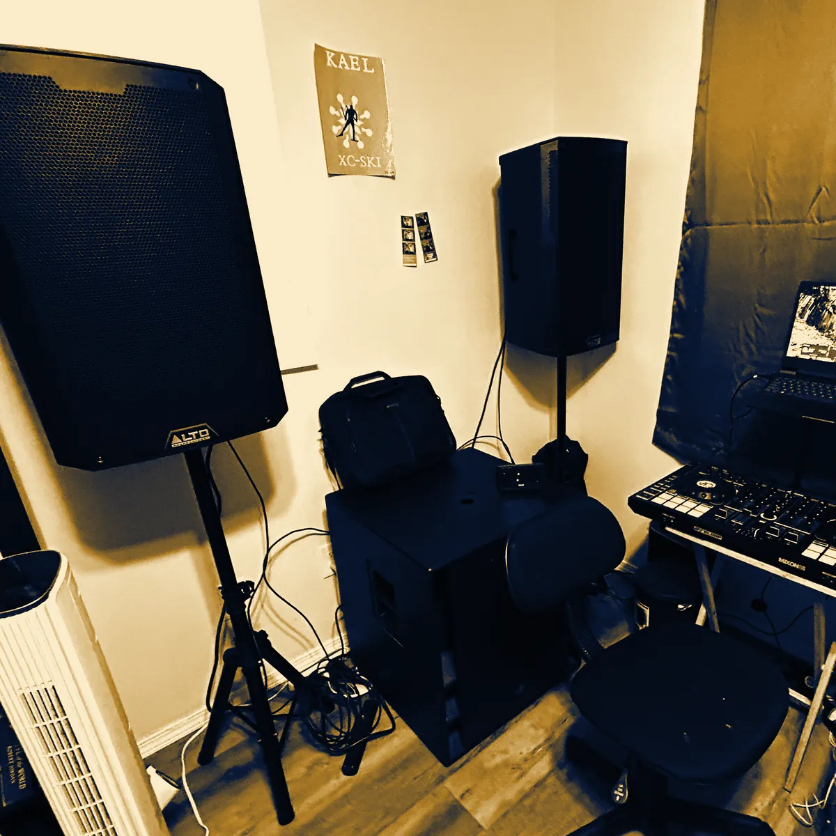 Two Alto 15-inch speakers on stands, the Mackie 18-inch subwoofer and the Mixon 8 Pro controller set up at DJ Zion's place